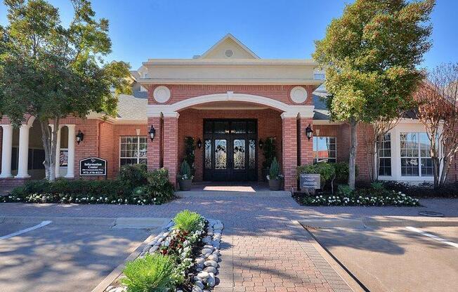 Plano, TX Apartments - Exterior View of Carrington Park Apartments Building Surrounded By Lush Landscaping