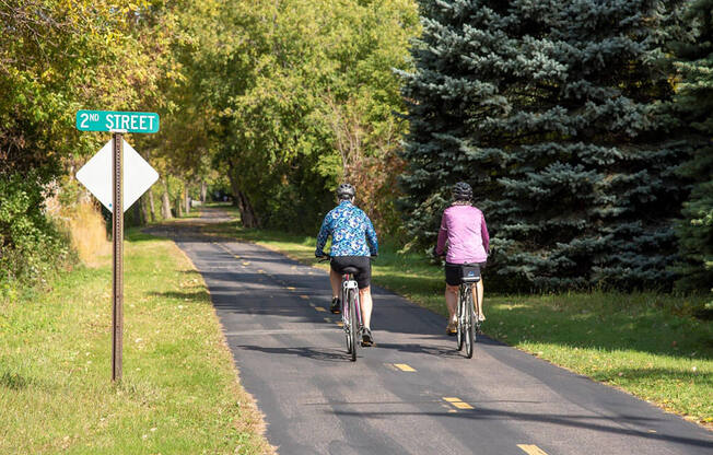 people biking on trails at Urban Park I and II Apartments, St Louis Park, MN
