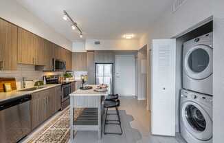 a kitchen with a washing machine and a washer and dryer