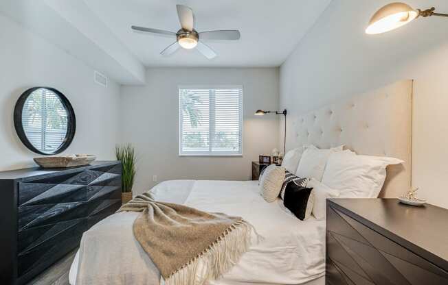 a bedroom with a bed and a ceiling fan