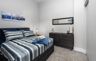 model bedrooms with carpeting, bed and dresser at The Residences at Delmar DivINe, St Louis, Missouri