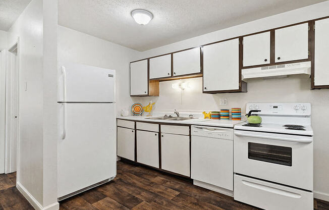 a white kitchen with white appliances and white cabinets