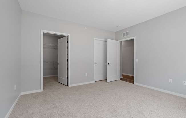 a bedroom with two closets at The Lodge at Overland, Rochester, MN, 55901