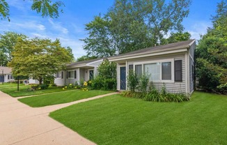 a white house with a yard and a sidewalk