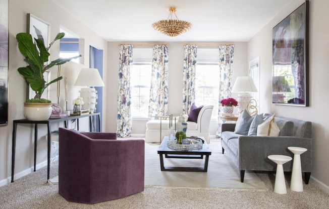 a neutral living room with purple accents