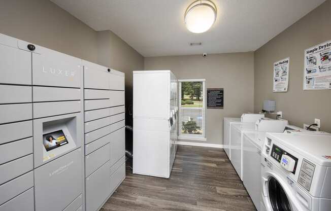 a laundry room with washer and dryers and a window