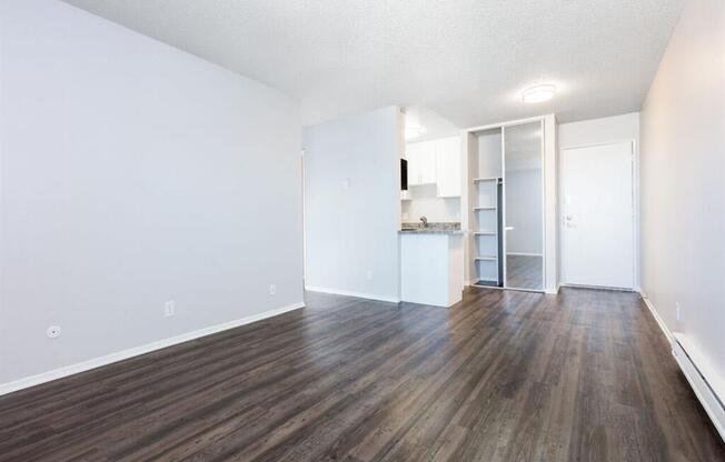 an empty living room with white walls and wood floors at Skyline Heights LLC, Daly City