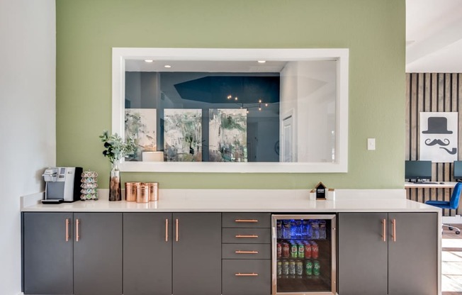 A kitchen with a green wall and a white counter.