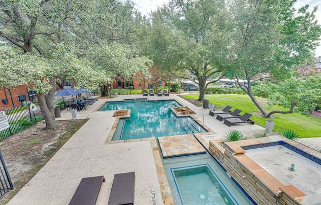 a backyard with a swimming pool and trees