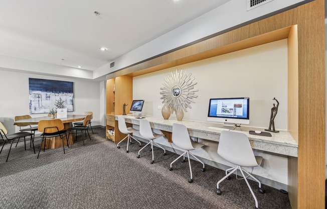 Resident business center with computers and workstations at River 595 Apartments