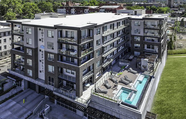 a drone shot of a pool and building at Lotus Republic Apartments for rent in Downtown Salt Lake City, Utah