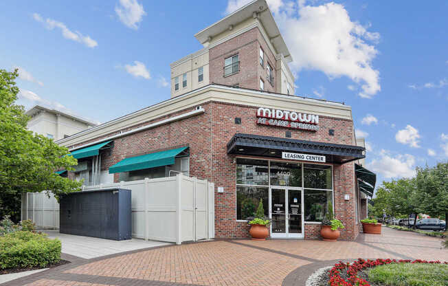 A brick building with a green awning and a sign that says "Midtown" on it.