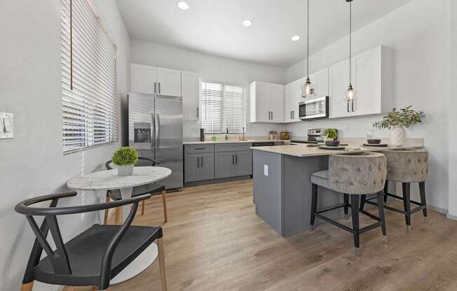 an open kitchen and dining area with a table and chairs