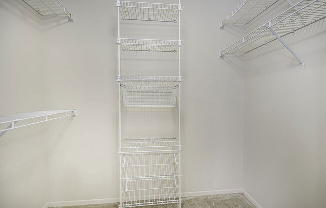 a white closet with wire shelving on the wall