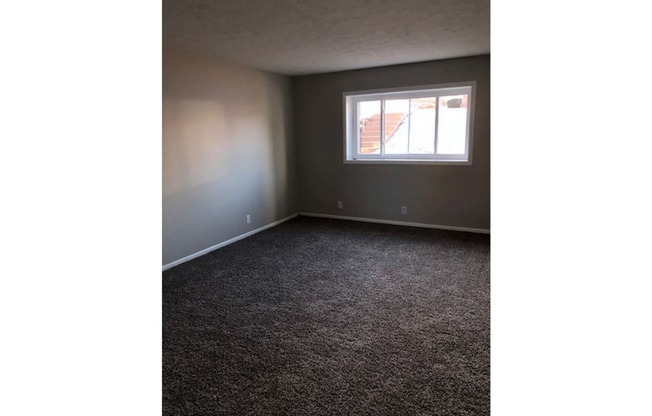 Living rooms with new carpet at The Flats on 75th in Omaha, NE