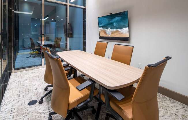 A conference room with a large table and chairs.