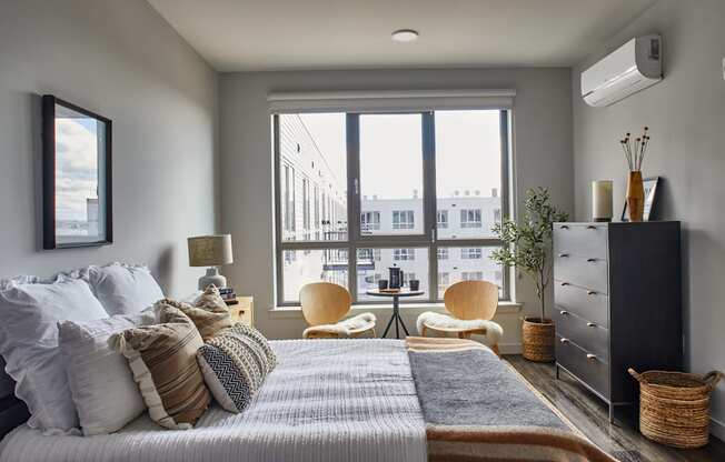 Bedroom with a bed and a large window at Sono Central Residential, Norwalk, CT