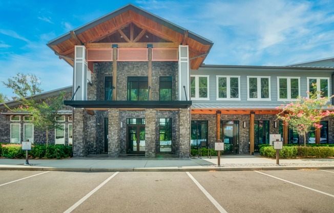 the front of a building with a parking lot