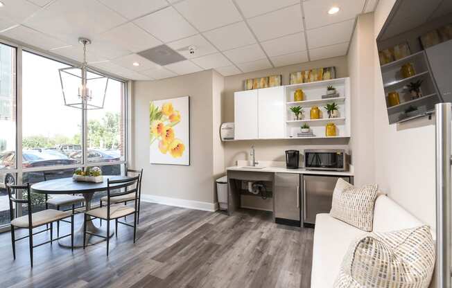 a living room and kitchen with a table and chairs