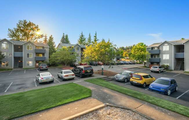 an aerial view of an apartment parking lot with cars