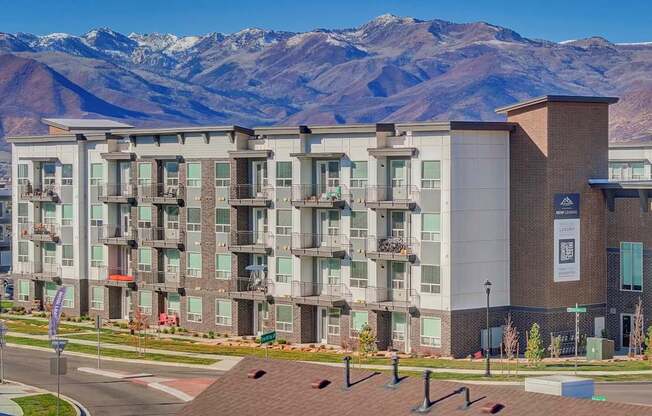 A large apartment complex with a mountain in the background.