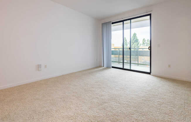 Carpeted Living Room with Balcony