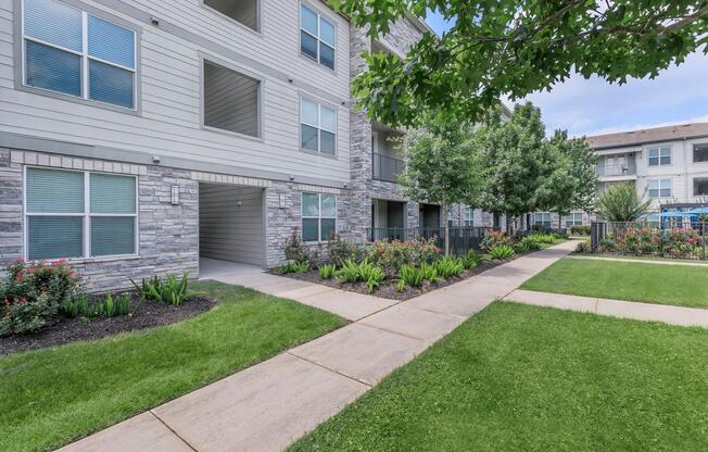 a large lawn in front of a brick building