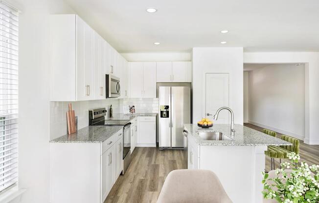 Bright cabinetry and sleek finishes in our Single Family Homes define this Amavi Celina kitchen, designed for effortless living with style and functionality.