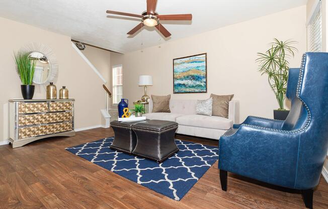 a living room filled with furniture and a blue chair