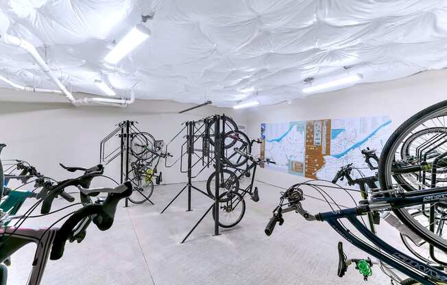a room filled with bikes and paintings on the wall at Aster Apartments, Ohio, 44122