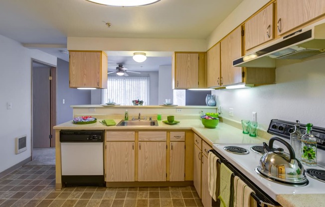 a kitchen with wooden cabinets and a stove and sink