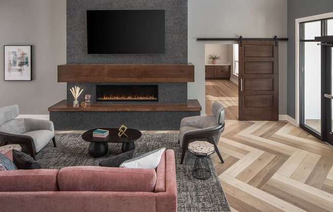 A living room with a fireplace and a television above it.