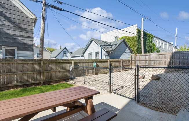 a picnic table in a fenced in area with a chain link fence