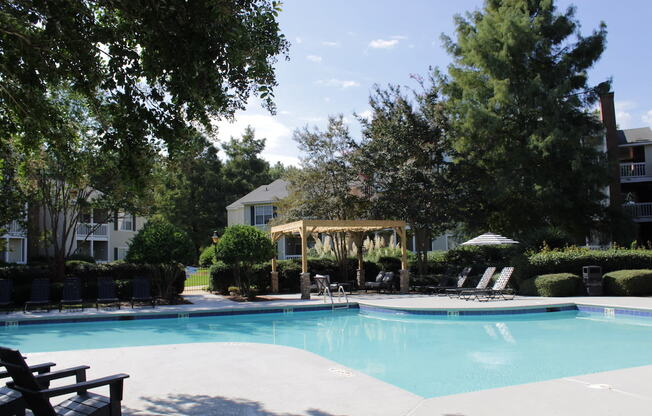 Large swimming pool and sundeck surrounded by trees at Stillwater at Grandview Cove