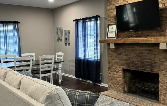 a living room with a couch and a table and a fireplace