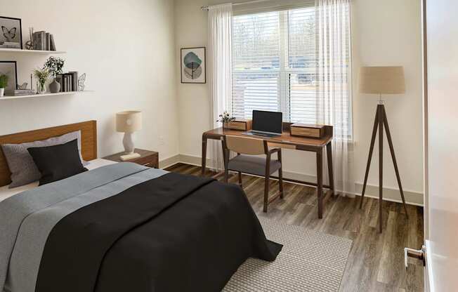 A bedroom with a bed, desk, and chair.