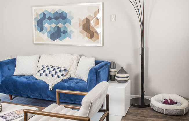 a living room with a blue couch and a large floor lamp at Fifteen 98 Naperville, Naperville, IL