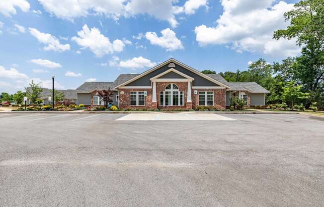 an empty parking lot in front of a house