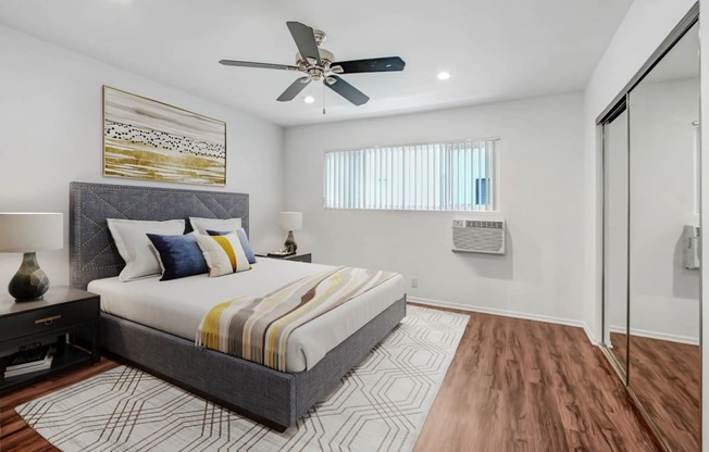 a bedroom with a bed and a ceiling fan