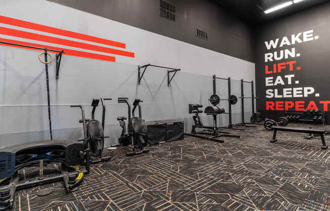 a gym with exercise equipment and a sign that reads wake run lift sleep