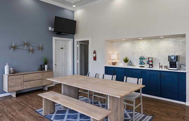 a dining room with a table and chairs and a kitchen