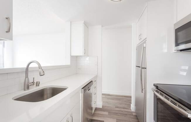 a kitchen with a sink and a refrigerator