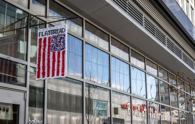 A flag that reads Flatbread Pizza Co. hanging up at Boston Landing, ALllston MA