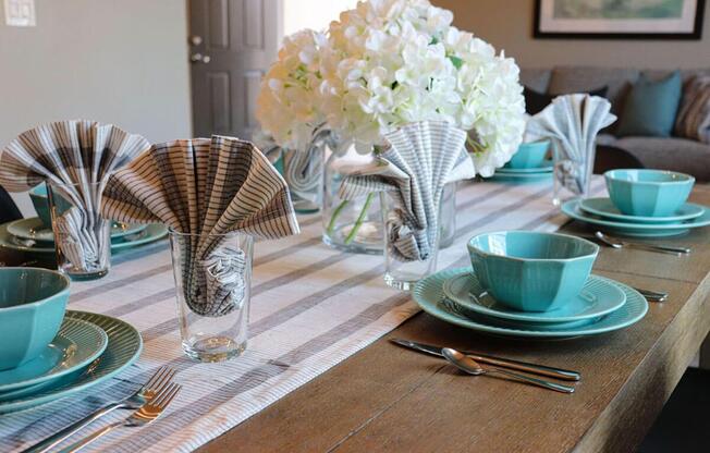 a cup of coffee and a vase of flowers on a table