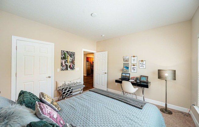 a bedroom with a bed and a desk with a chair