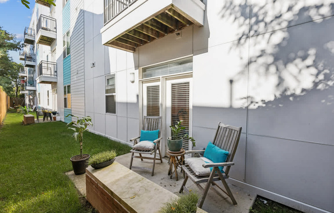A small patio with two chairs and a table.