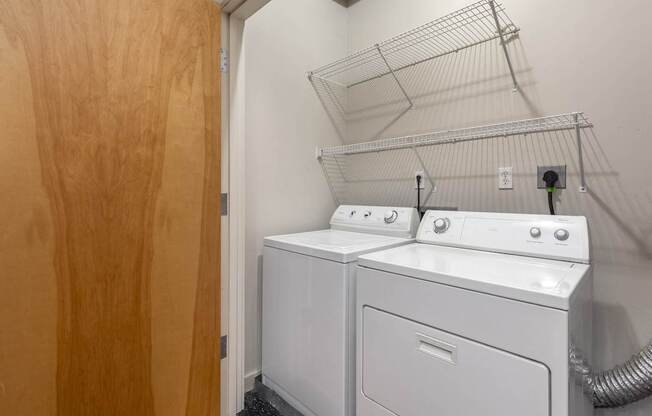 the laundry room has a washer and dryer and a door to the closet