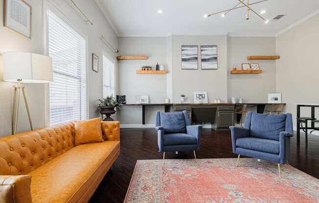 a living room with a yellow couch and two blue chairs
