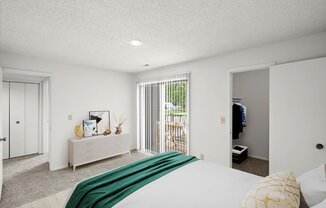 a bedroom with white walls and a green blanket on the bed