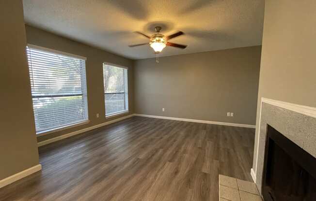 The Forest at Duck Creek Apartments Renovated Living Room with Fireplace and Large Windows